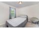 This bedroom features a comfortable air mattress, bright natural light from the window, and a round chair at 152 Grassy Meadow Ln, Statesville, NC 28625