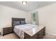 Cozy bedroom featuring a queen-sized bed, stylish gray headboard, and neutral decor with natural light at 152 Grassy Meadow Ln, Statesville, NC 28625