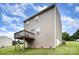 Backyard view of the house showcasing a deck, neutral siding, and a well-maintained lawn at 152 Grassy Meadow Ln, Statesville, NC 28625