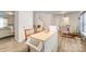 Open-concept kitchen and dining area with wood-look floors and bright natural light at 152 Grassy Meadow Ln, Statesville, NC 28625