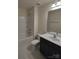 Bright bathroom features a shower-tub combo, modern vanity with sink, and a white tiled backsplash at 15239 Wrights Crossing Dr, Charlotte, NC 28278