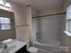 A full bathroom with a tub/shower combo and a view of the exterior from the window at 15239 Wrights Crossing Dr, Charlotte, NC 28278