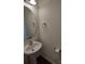 Cozy half-bathroom with a pedestal sink, oval mirror, and neutral décor at 15239 Wrights Crossing Dr, Charlotte, NC 28278