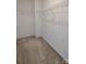 A neutral-colored walk-in closet with upper shelving at 15239 Wrights Crossing Dr, Charlotte, NC 28278