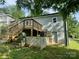 The back exterior features a wooden deck, stairs, access door, and a gray-painted wall at 16 Cherry St, Albemarle, NC 28001