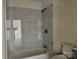 Modern bathroom features marble tiled shower, with a built-in soap niche, tub, and new fixtures at 16 Cherry St, Albemarle, NC 28001