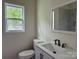 This bathroom features a bright window, modern sink, and a beautiful tiled shower at 16 Cherry St, Albemarle, NC 28001