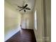 The bedroom includes vinyl floors, a ceiling fan, and bright window at 16 Cherry St, Albemarle, NC 28001
