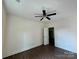 This bedroom has vinyl floors, a ceiling fan, and a door leading to a closet at 16 Cherry St, Albemarle, NC 28001