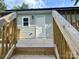 Exterior view of the deck showcasing wood planking and a white door with a window at 16 Cherry St, Albemarle, NC 28001