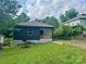 Charming home featuring a decorative wood porch, black siding, and a well-maintained front yard at 16 Cherry St, Albemarle, NC 28001