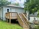 Exterior view of back of house featuring a wooden deck and stairs to backyard at 16 Cherry St, Albemarle, NC 28001