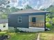 Home exterior showing a charming decorative wood porch and updated siding at 16 Cherry St, Albemarle, NC 28001
