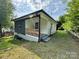 Home exterior showing a charming decorative wood porch and updated siding at 16 Cherry St, Albemarle, NC 28001