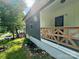 Home exterior displaying the yard, stone landscaping and wooden porch featuring a wooden railing at 16 Cherry St, Albemarle, NC 28001