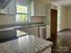 Updated kitchen featuring stainless steel appliances, granite countertops, and white cabinets at 16 Cherry St, Albemarle, NC 28001