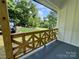 The home features a cozy porch with new wooden railing and blue painted floorboards at 16 Cherry St, Albemarle, NC 28001