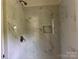 This tiled shower includes a built-in niche, and a new bronze shower head at 16 Cherry St, Albemarle, NC 28001