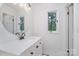This bathroom offers a white countertop and cabinet space, and a decorative mirror at 1601 Wandering Way Dr, Charlotte, NC 28226