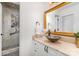 Bathroom featuring a vessel sink, framed mirror, and mosaic tiled shower at 1601 Wandering Way Dr, Charlotte, NC 28226