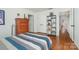 View of this bedroom with hardwood floors, built-in shelving, and access to the home's hallway at 1601 Wandering Way Dr, Charlotte, NC 28226