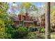 View of the back of this home, showcasing the enclosed porch and tree-lined yard at 1601 Wandering Way Dr, Charlotte, NC 28226
