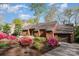 Inviting home with brick driveway framed by vibrant azaleas and manicured landscaping at 1601 Wandering Way Dr, Charlotte, NC 28226
