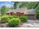 A well-maintained home with a brick driveway and garage complemented by lush greenery and mature trees surrounding the property at 1601 Wandering Way Dr, Charlotte, NC 28226