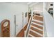 Bright foyer featuring hardwood floors, staircase, and decorative grandfather clock at 1601 Wandering Way Dr, Charlotte, NC 28226