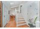 Bright foyer featuring hardwood floors, a staircase, and an adjacent dining area, creating a welcoming and elegant entry at 1601 Wandering Way Dr, Charlotte, NC 28226