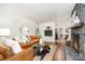 Bright living room featuring stone fireplace, leather sofa, and view to dining area at 1601 Wandering Way Dr, Charlotte, NC 28226