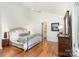 Spacious main bedroom with hardwood floors, ceiling fan, and ensuite bathroom at 1601 Wandering Way Dr, Charlotte, NC 28226