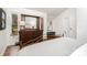 Main bedroom showcasing hardwood floors, a dark wood dresser with mirror and view to outside at 1601 Wandering Way Dr, Charlotte, NC 28226