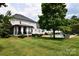 Expansive backyard featuring a swimming pool, patio area, screened porch, and lush landscaping at 19625 Callaway Hills Ln, Davidson, NC 28036