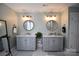 Elegant bathroom with dual vanities, round mirrors, and soft, natural light at 19625 Callaway Hills Ln, Davidson, NC 28036