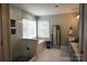 Bright bathroom with a walk-in shower, soaking tub, and modern fixtures at 19625 Callaway Hills Ln, Davidson, NC 28036