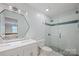 Bathroom featuring double sinks, white cabinets, and a walk-in shower with glass doors at 19625 Callaway Hills Ln, Davidson, NC 28036