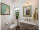 Cozy bathroom with stylish fixtures, bright natural light, and decorative mirror at 19625 Callaway Hills Ln, Davidson, NC 28036
