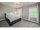 Cozy bedroom featuring a queen-sized bed, neutral walls, and natural light from two windows at 19625 Callaway Hills Ln, Davidson, NC 28036