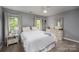 Cozy bedroom featuring neutral walls, carpet, a comfortable bed, and ample natural light from the windows at 19625 Callaway Hills Ln, Davidson, NC 28036