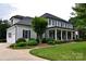 Side view of a gray two-story home with a white garage, front porch, and manicured lawn at 19625 Callaway Hills Ln, Davidson, NC 28036