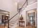 Elegant foyer featuring hardwood floors, staircase with white railings, and views into dining and living rooms at 19625 Callaway Hills Ln, Davidson, NC 28036