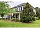 Charming home with a covered front porch, rocking chairs, and meticulously maintained landscaping at 19625 Callaway Hills Ln, Davidson, NC 28036