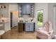 Kitchen bar with wine storage, glass cabinets, beverage cooler, and backyard views at 19625 Callaway Hills Ln, Davidson, NC 28036