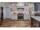 Gourmet kitchen with stainless steel range, custom hood, designer cabinets and hardwood floors at 19625 Callaway Hills Ln, Davidson, NC 28036