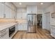 Well-lit kitchen featuring stainless steel appliances, designer cabinets, and tile backsplash at 19625 Callaway Hills Ln, Davidson, NC 28036