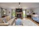 Comfortable living room with a stone fireplace, plush seating, and plenty of natural light at 19625 Callaway Hills Ln, Davidson, NC 28036