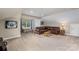 Living room boasts a large leather sectional couch, neutral colors, and natural light from the window at 19625 Callaway Hills Ln, Davidson, NC 28036