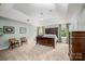 Spacious main bedroom with a tray ceiling, neutral carpet, and large windows providing natural light at 19625 Callaway Hills Ln, Davidson, NC 28036