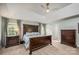 Comfortable main bedroom with a tray ceiling, neutral carpet, and dark wood bedroom furniture at 19625 Callaway Hills Ln, Davidson, NC 28036
